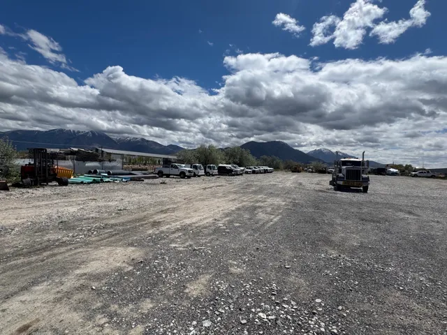 Expansive gravel lot with mountain scenery