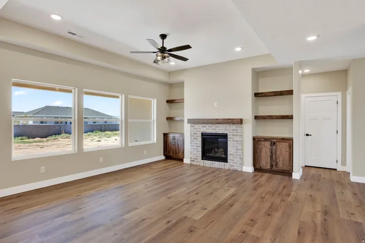 Spacious open concept room featuring wood-finish flooring, a contemporary ceiling fan, and recessed lighting