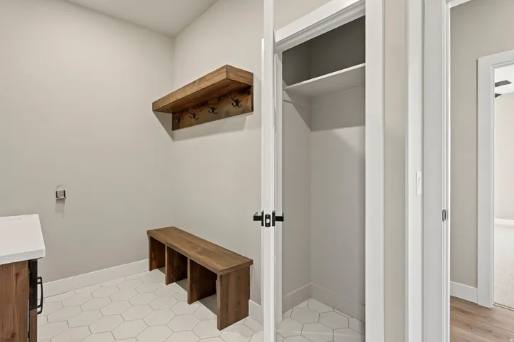 Laundry area featuring white hexagonal floor tiling
