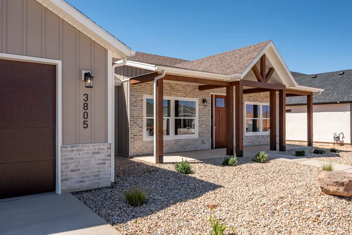 Contemporary exterior featuring light brick and vertical siding