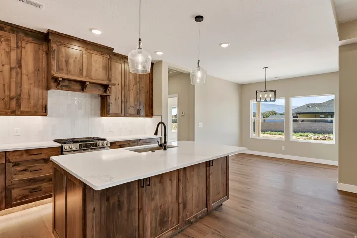 Kitchen featuring wood-finish cabinetry, white countertops, and a white subway tile backsplash
