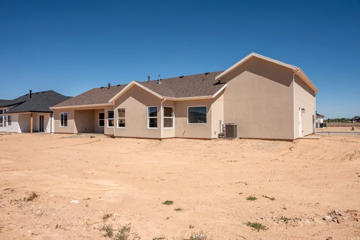 Contemporary stucco exterior with a multi-pitch shingle roof
