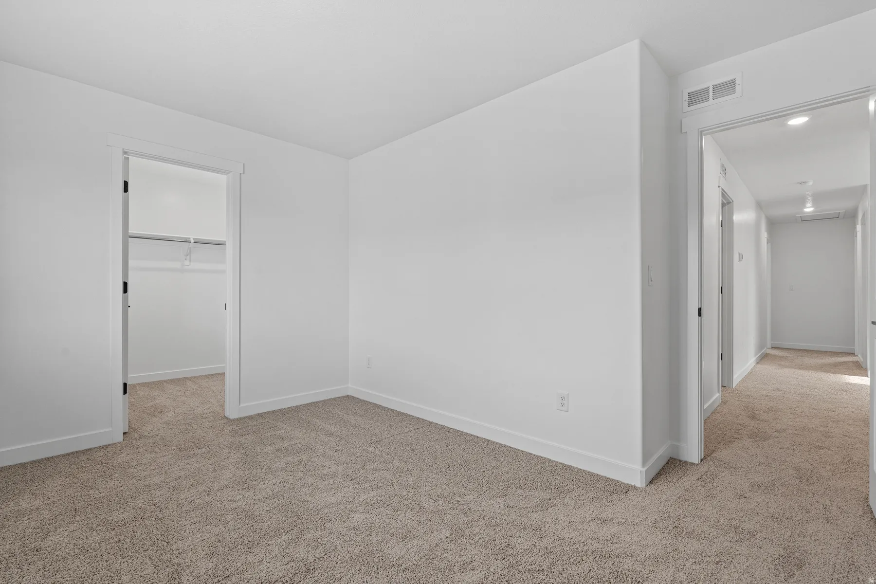 Carpeted interior space featuring white walls and white trim