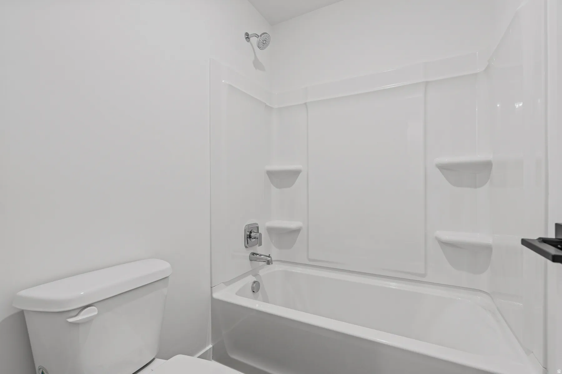 White fiberglass tub/shower combination with integrated shelving