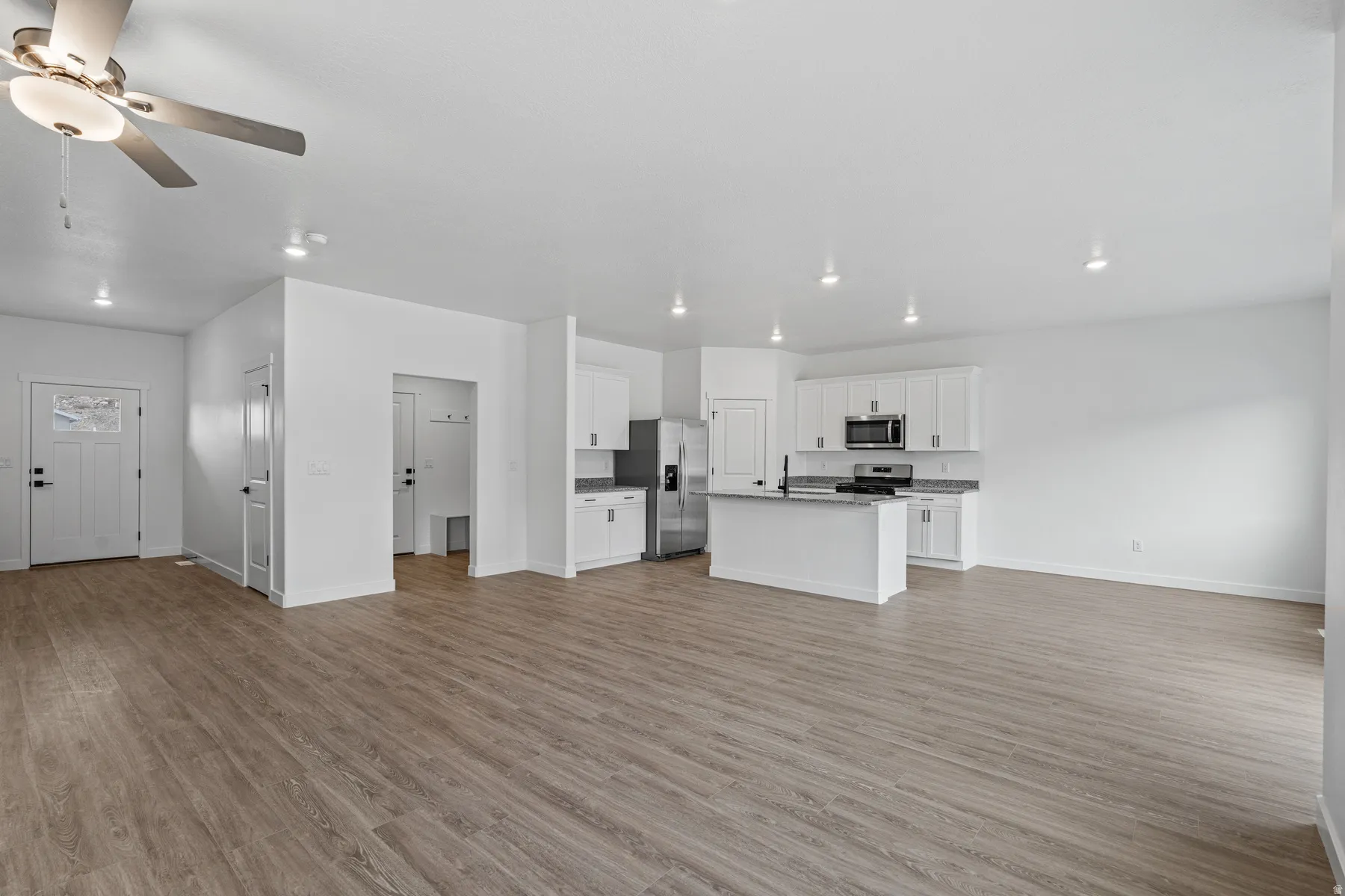 Spacious open-concept interior featuring wood-finish flooring throughout