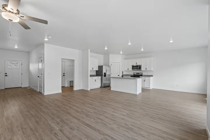 Spacious open-concept interior featuring wood-finish flooring throughout