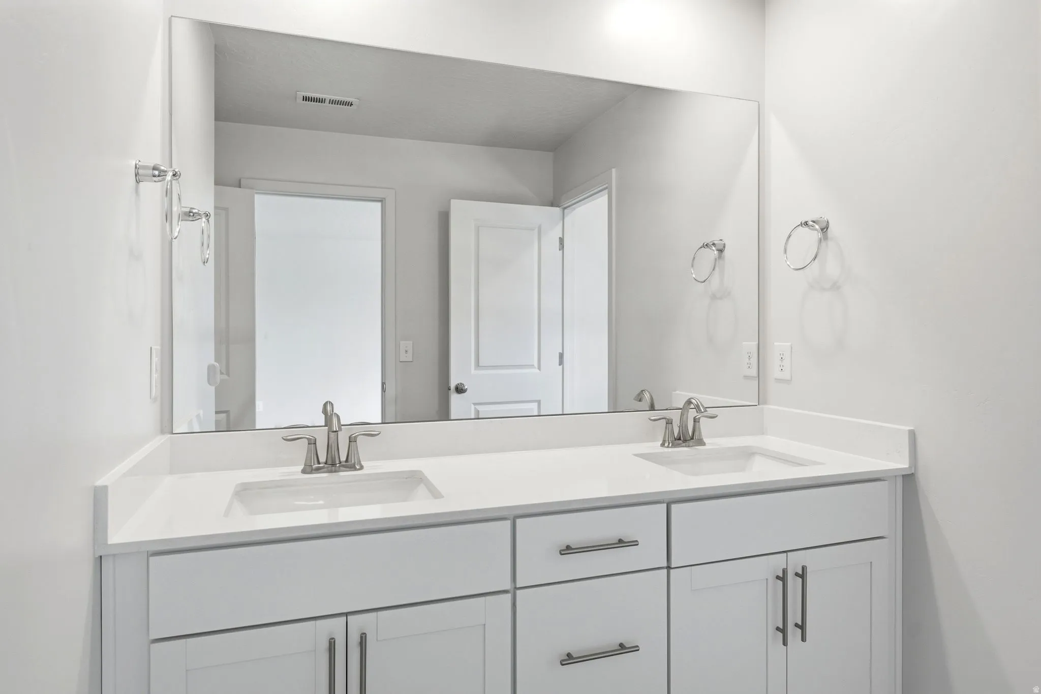 Double vanity with integrated rectangular sinks and white countertops