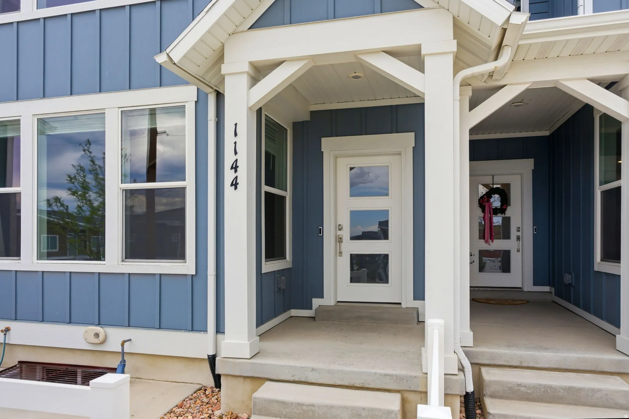 Modern facade with blue vertical siding and white trim