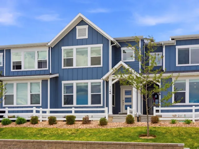 Contemporary blue exterior featuring white trim and multiple windows