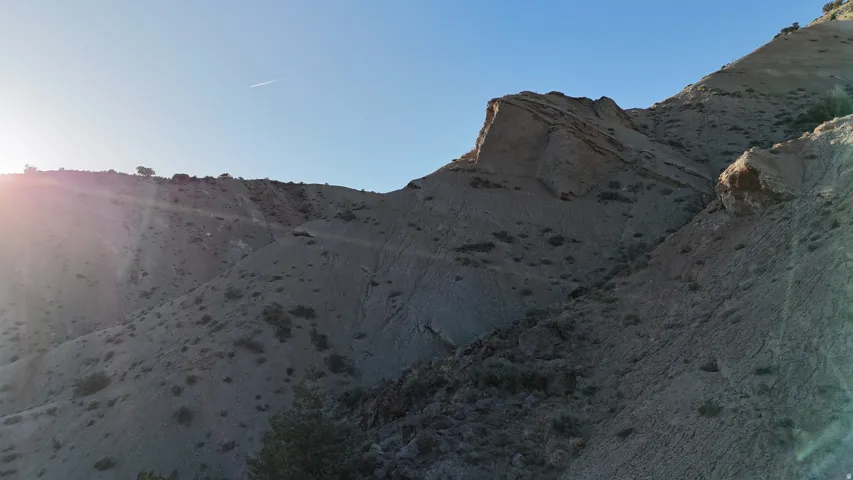 Expansive desert hills featuring natural rock formations and sparse vegetation