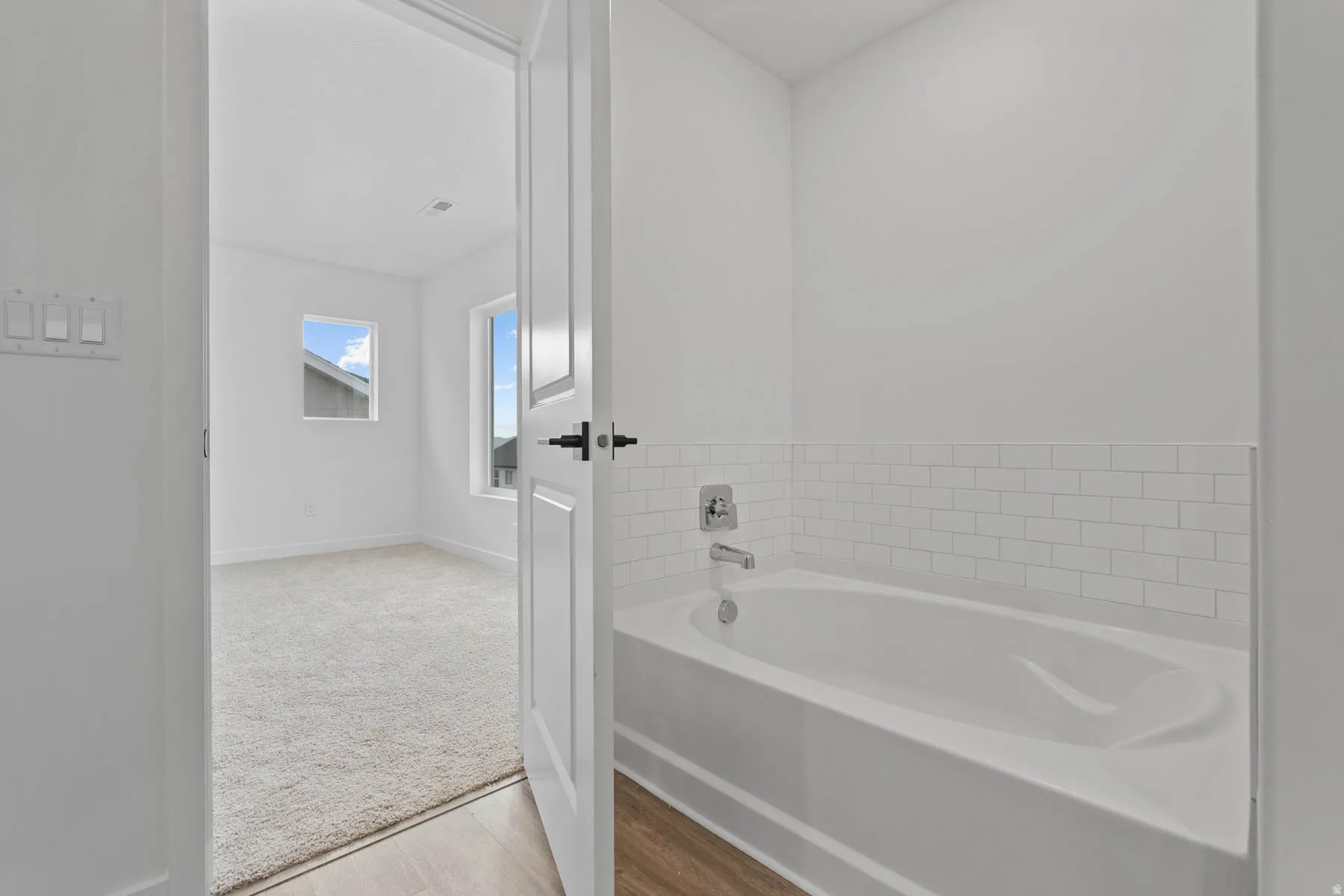 Bathtub with subway tile surround and chrome fixtures