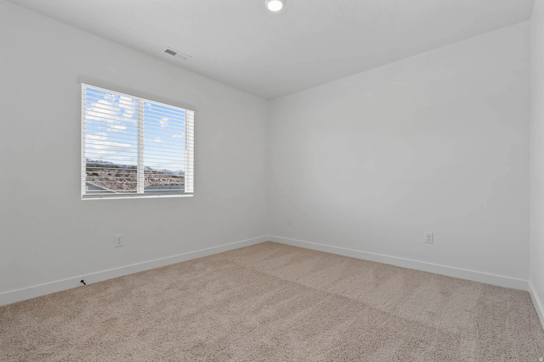 Neutral-toned carpeting complements the white walls and trim