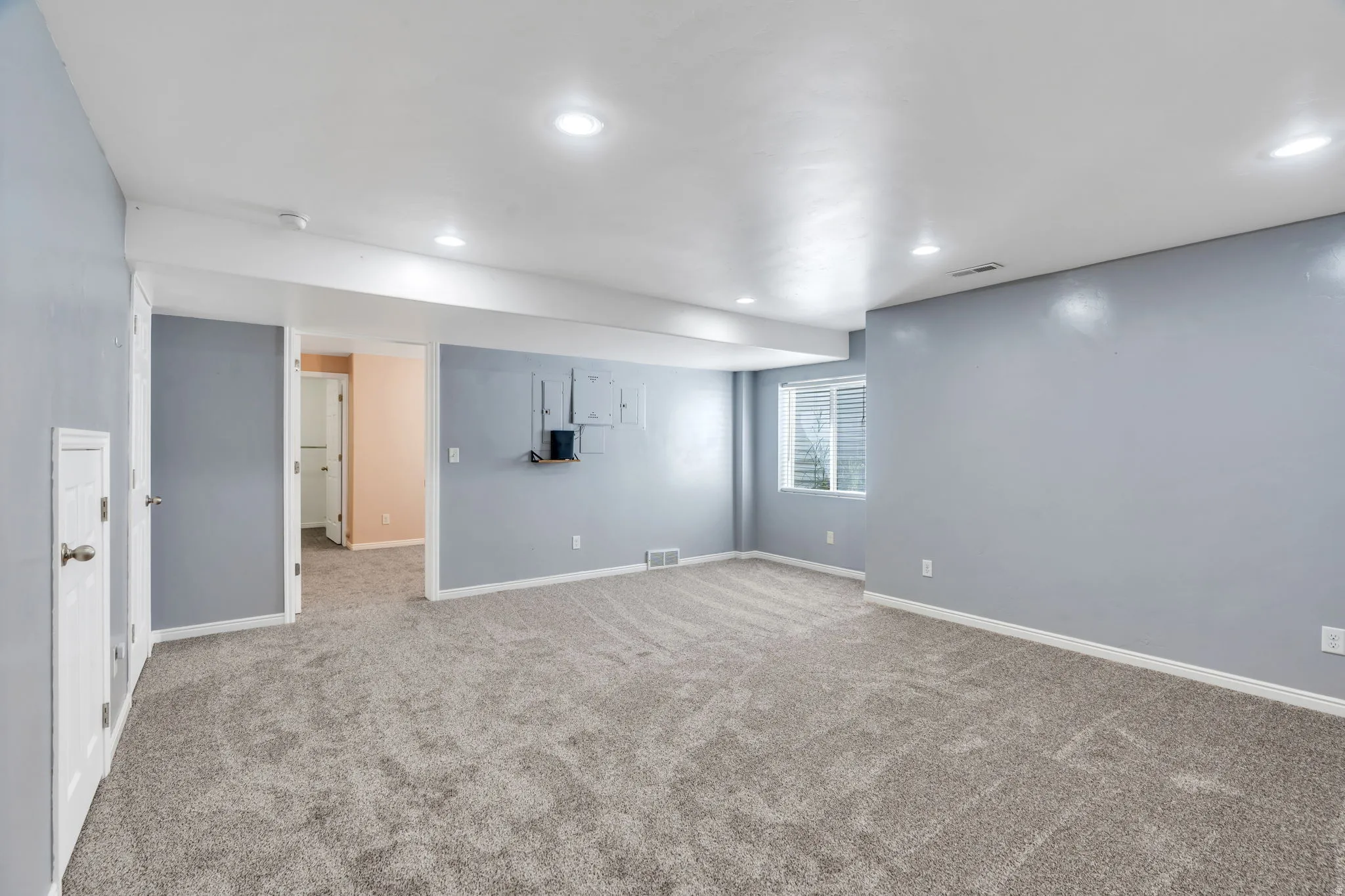 Basement featuring light colored carpet and recessed lighting