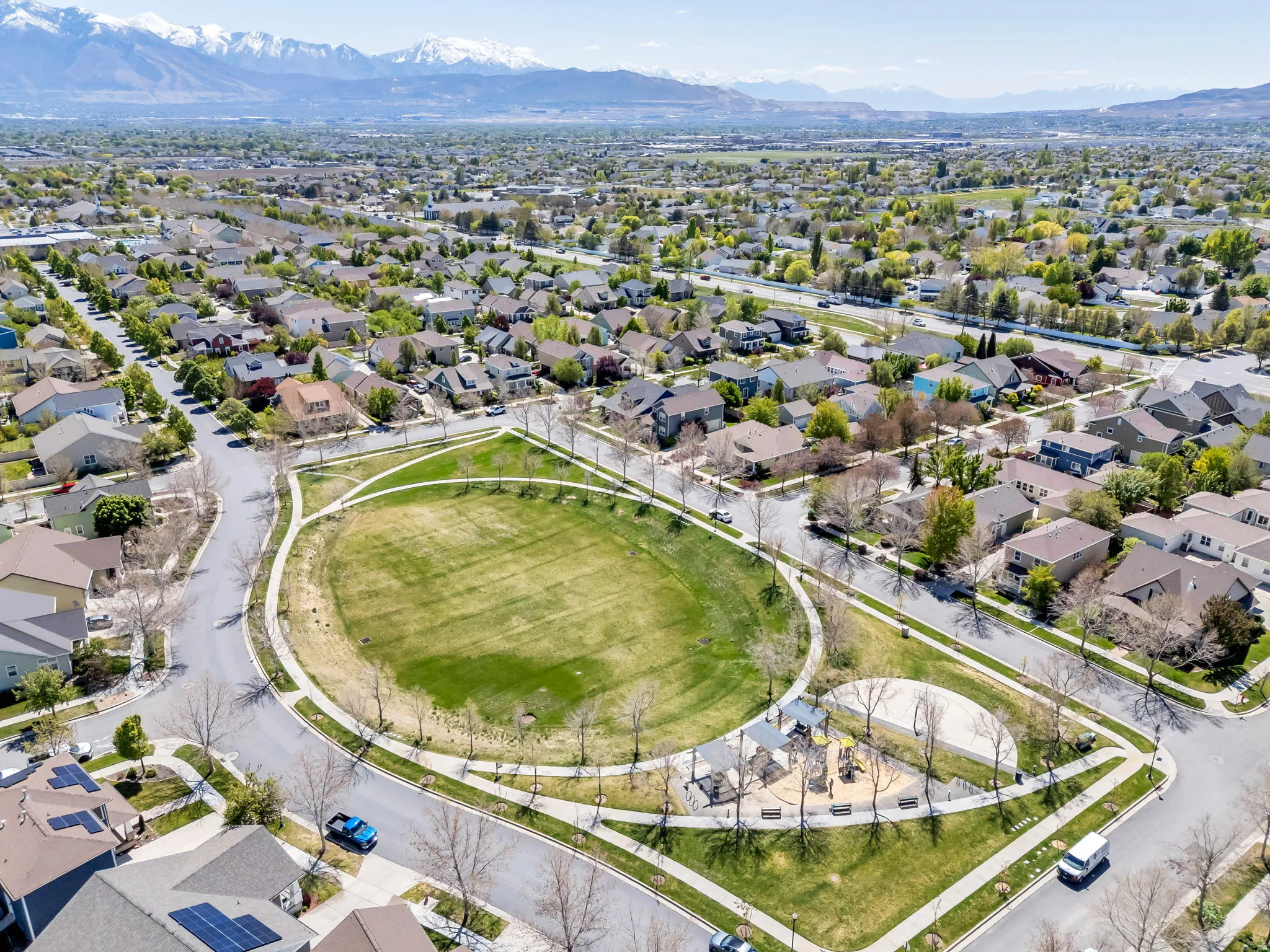Aerial perspective of suburban area with a mountainous background