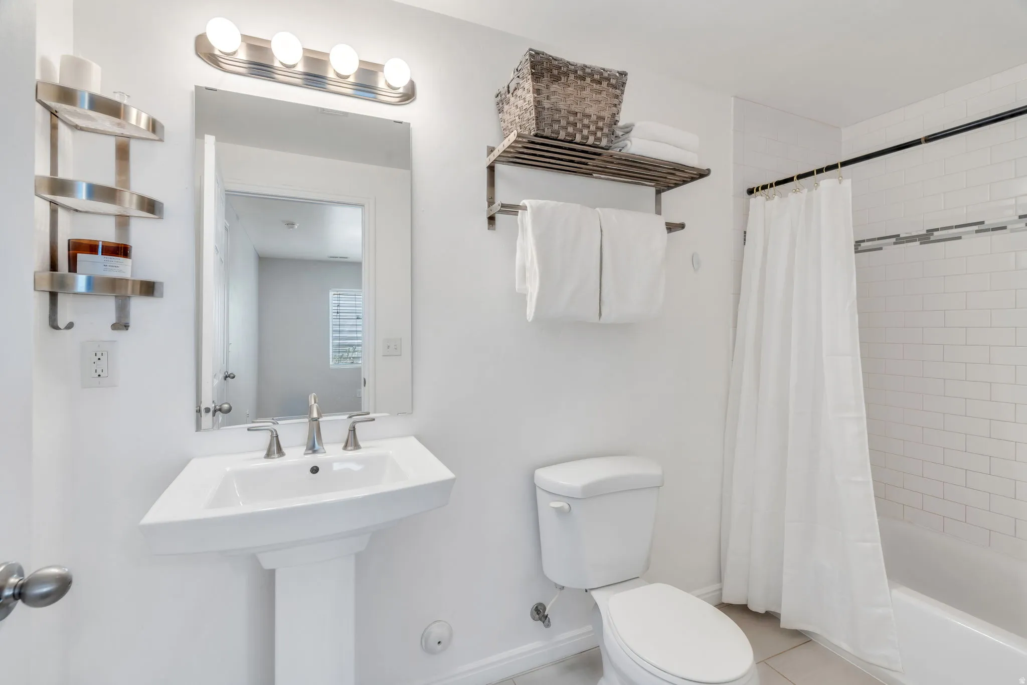 Full bath featuring shower / bath combo with shower curtain and light tile patterned flooring