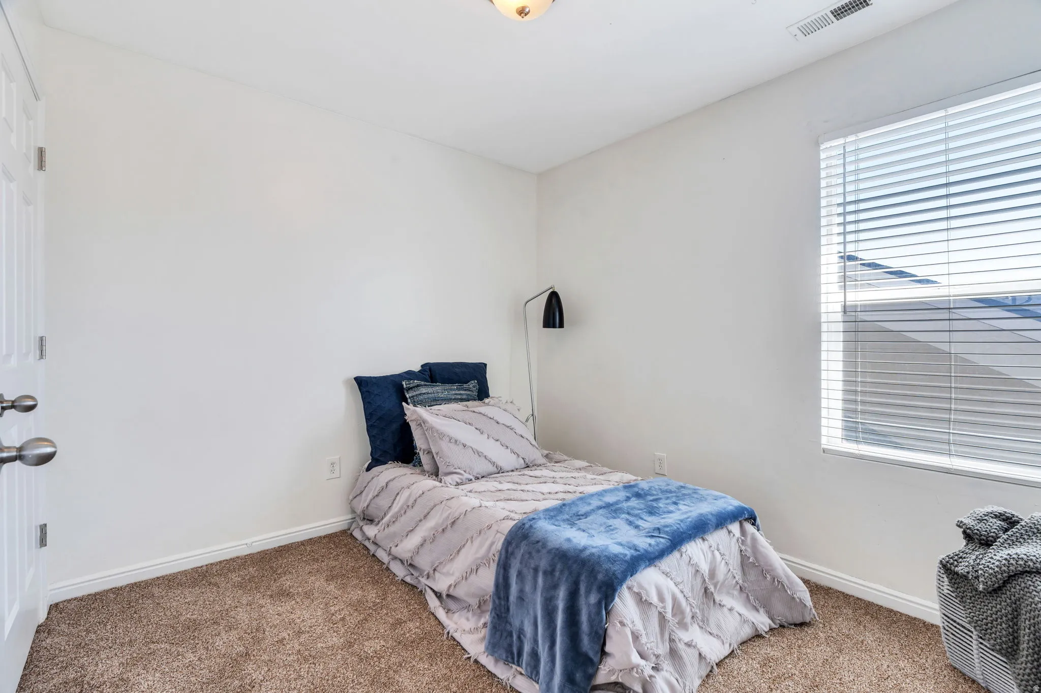Bedroom featuring carpet floors and baseboards