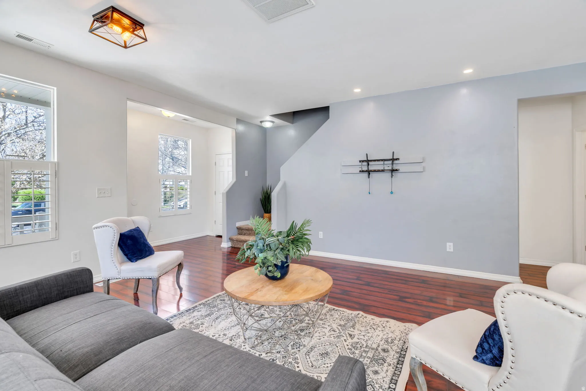 Living room featuring wood finished floors and recessed lighting