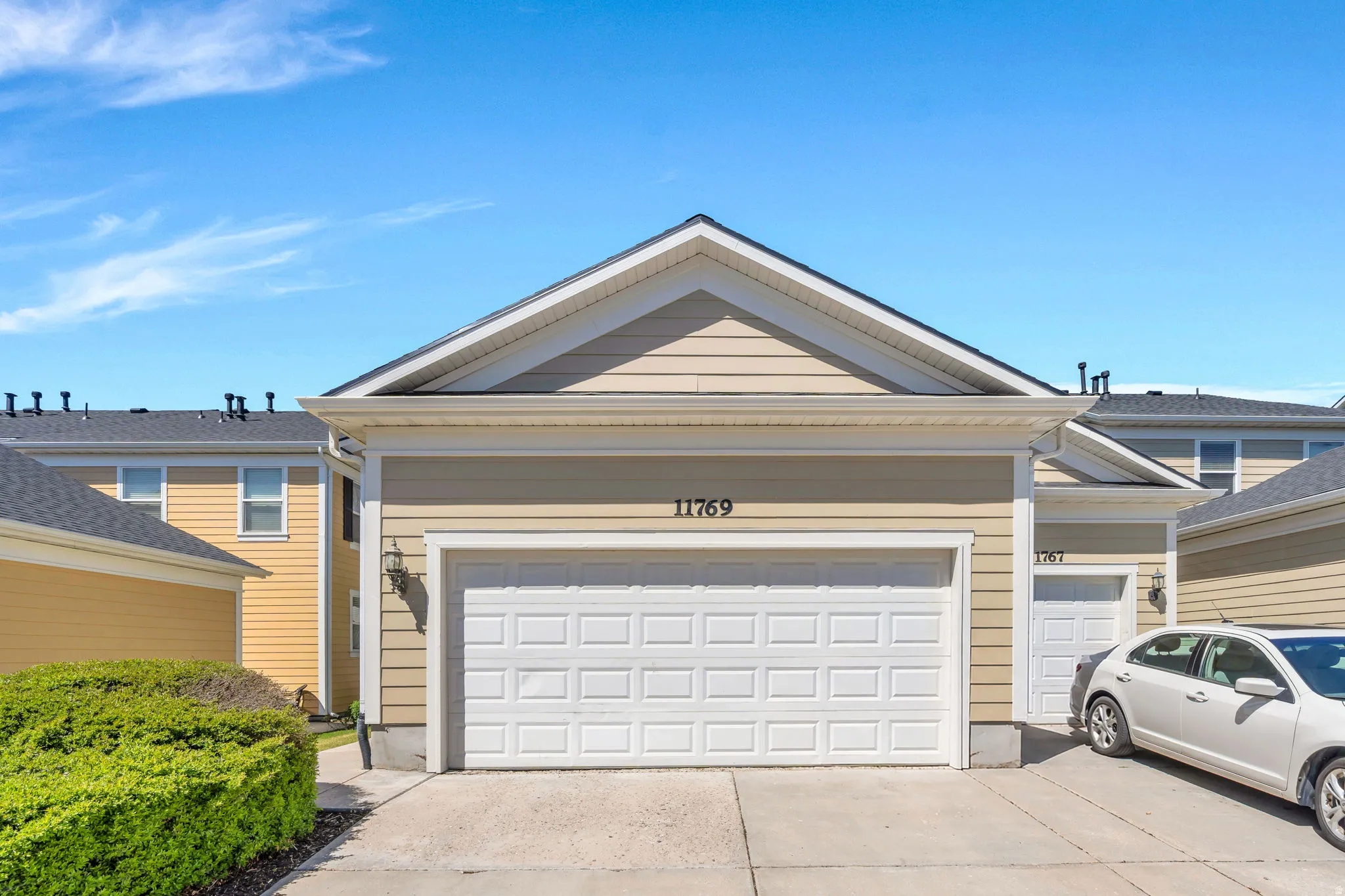 Ranch-style house featuring a garage and concrete driveway