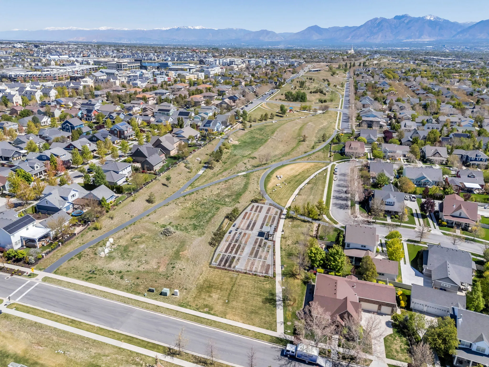 Aerial overview of property's location featuring nearby suburban area and a mountain backdrop