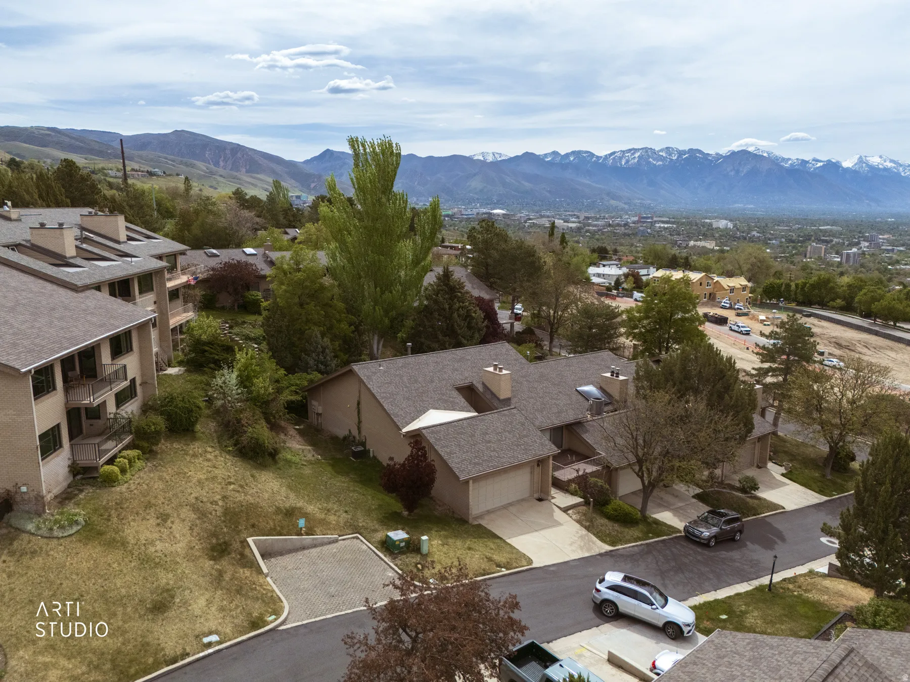 Aerial view of property showing neighborhood and mountain background.