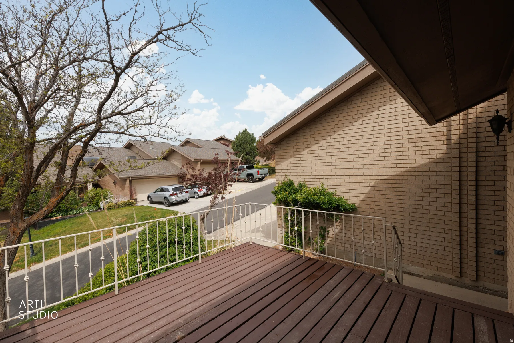Outdoor deck featuring wood-finish flooring and a decorative white railing