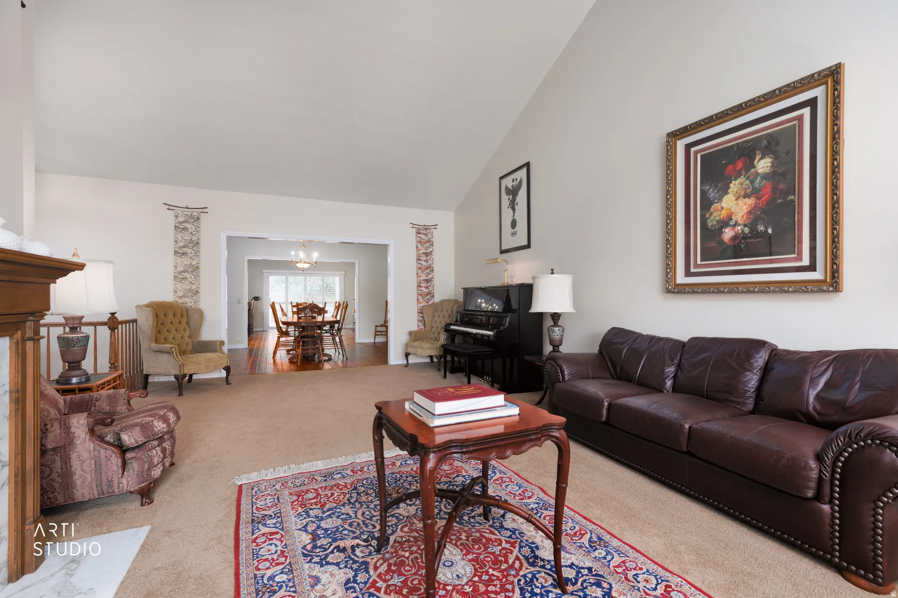 Spacious living area with vaulted ceilings and neutral wall tones