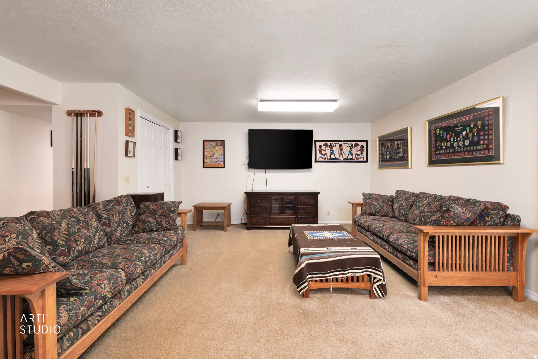 Spacious room with light neutral carpeting and white walls