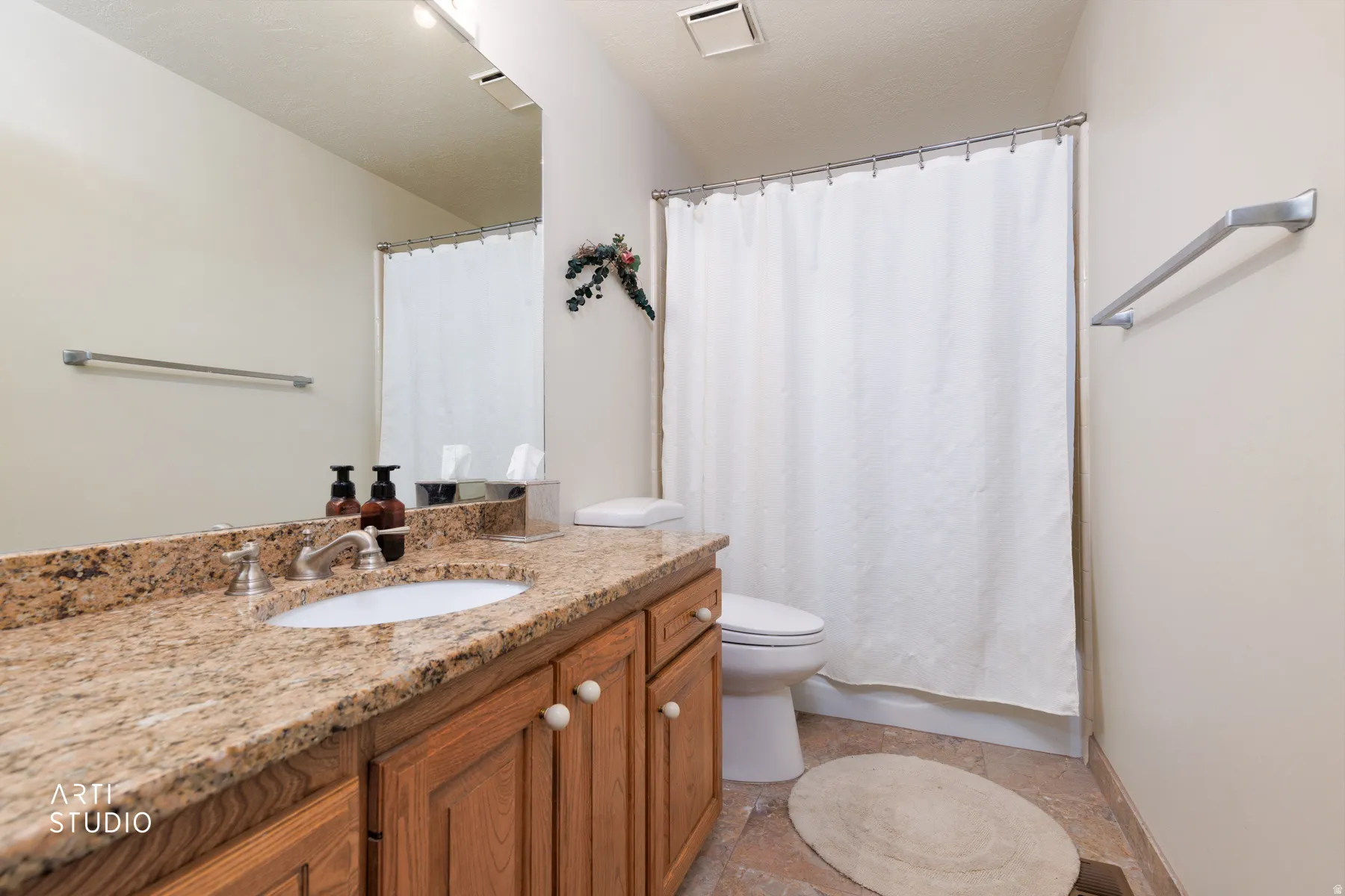 Master bathroom featuring a vanity with granite countertop, integrated sink, and wood cabinetry