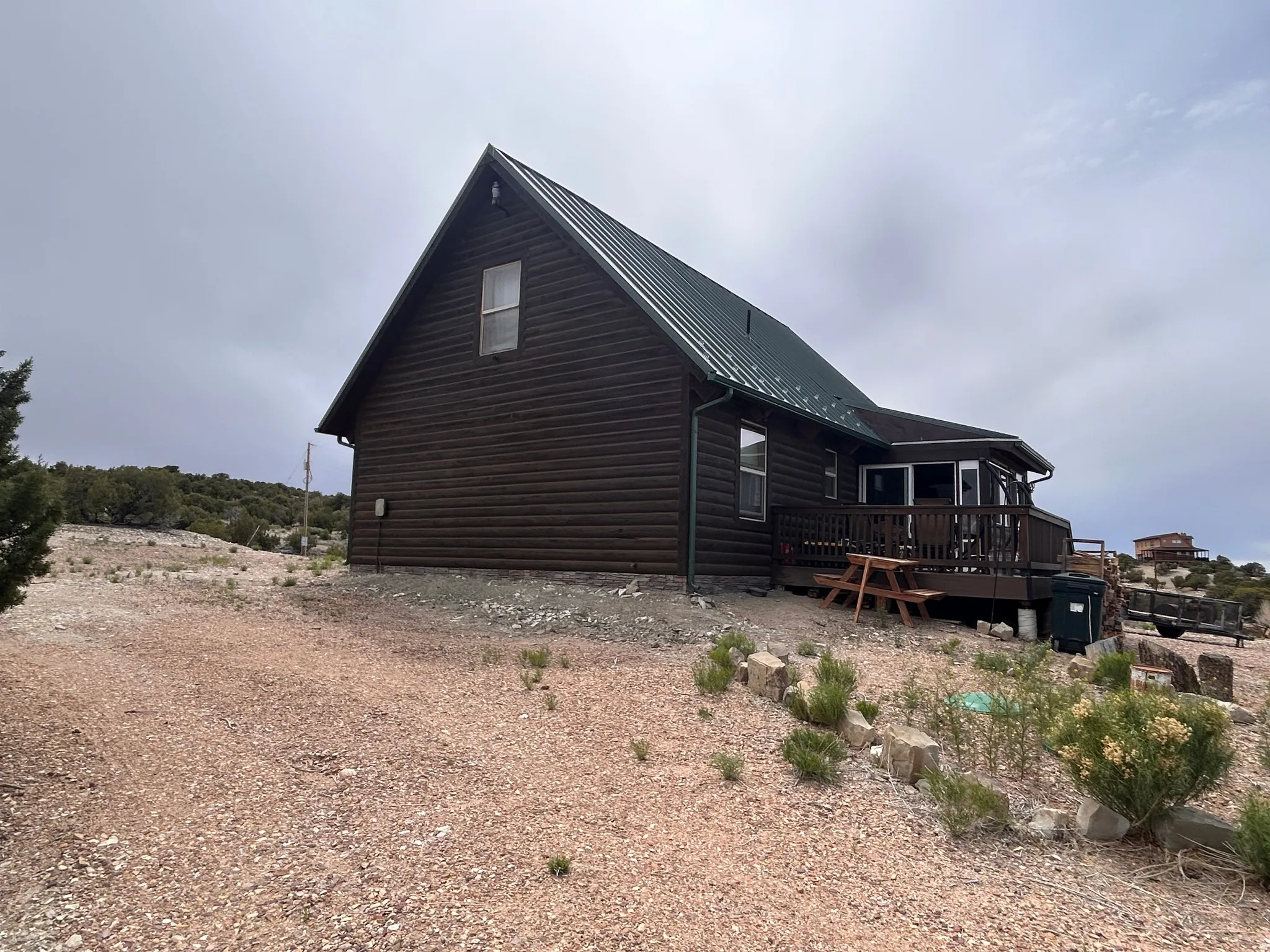 Log-sided residence featuring a dark green metal roof