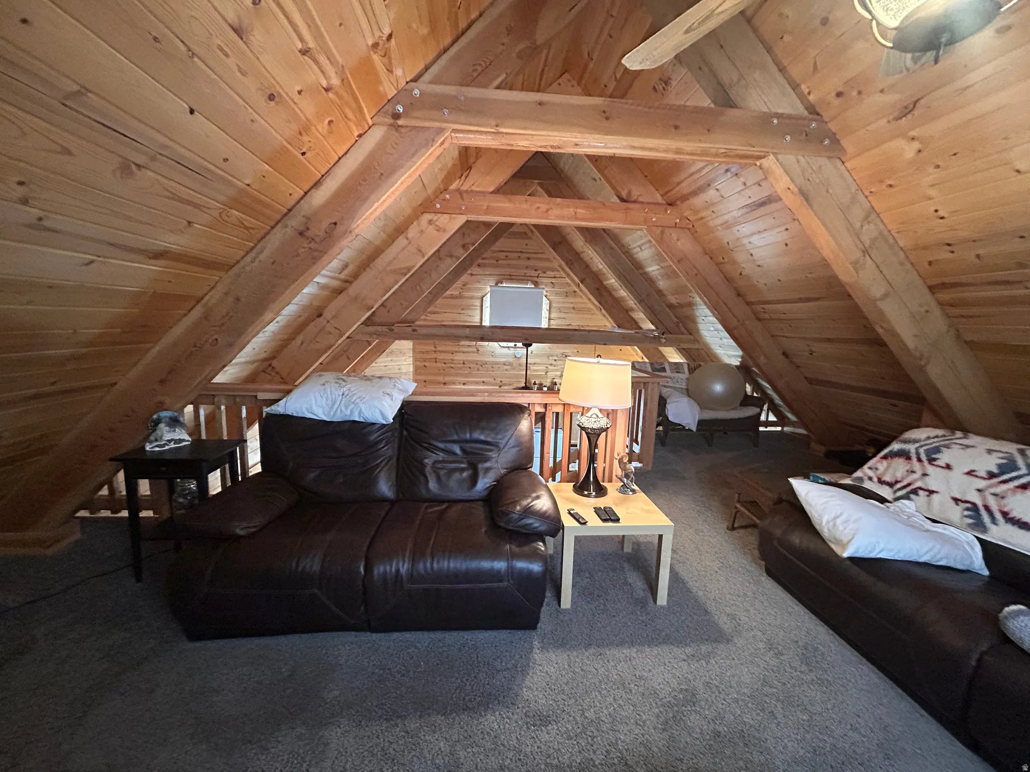 Vaulted wood-paneled ceiling with exposed beams