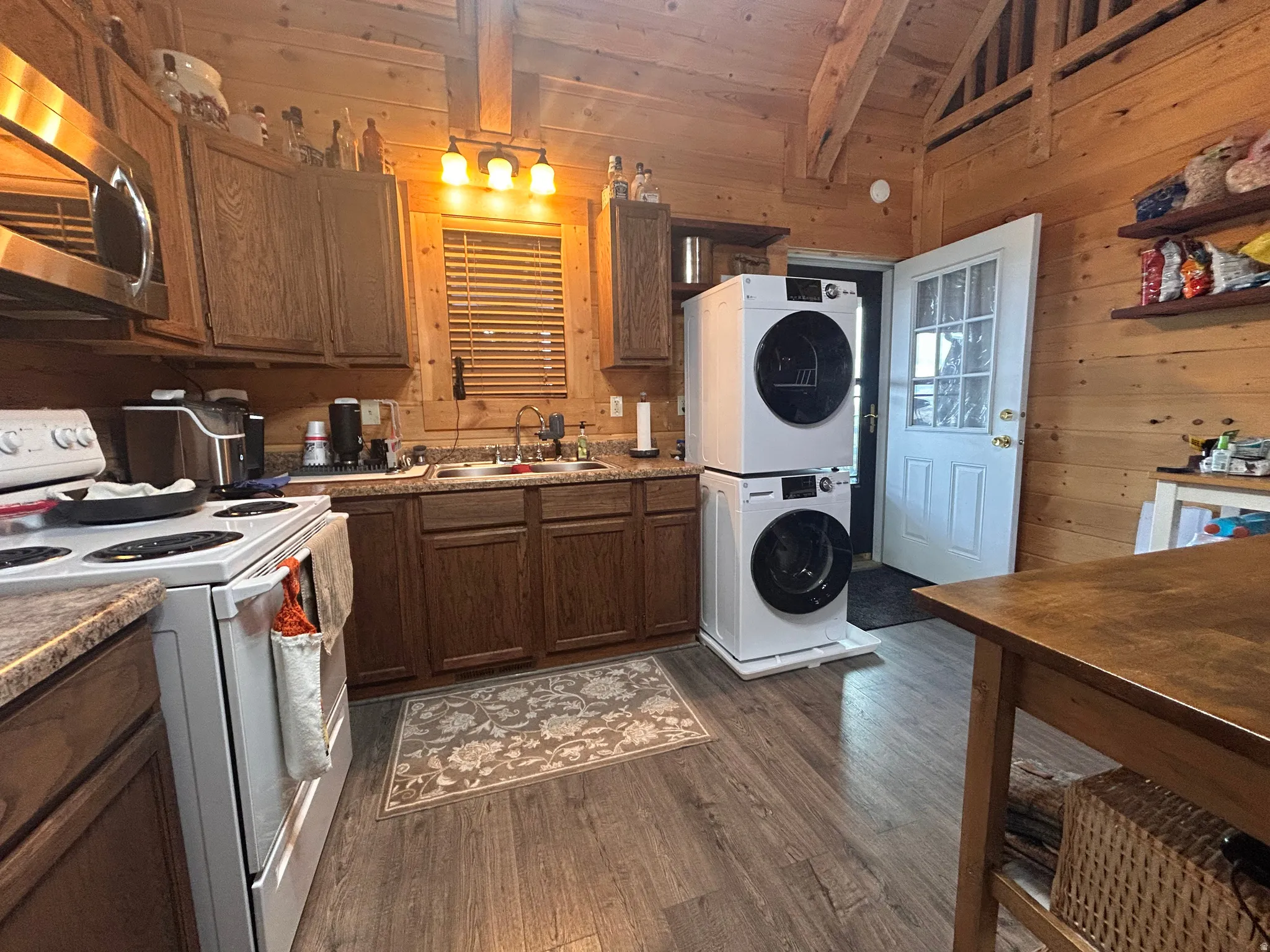 Kitchen area featuring wood-finish flooring, wood cabinetry, and laminate countertops