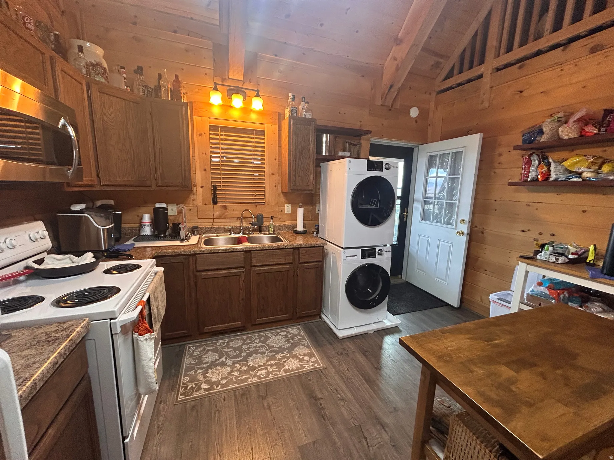 Kitchen area featuring wood-finish flooring and wood paneling