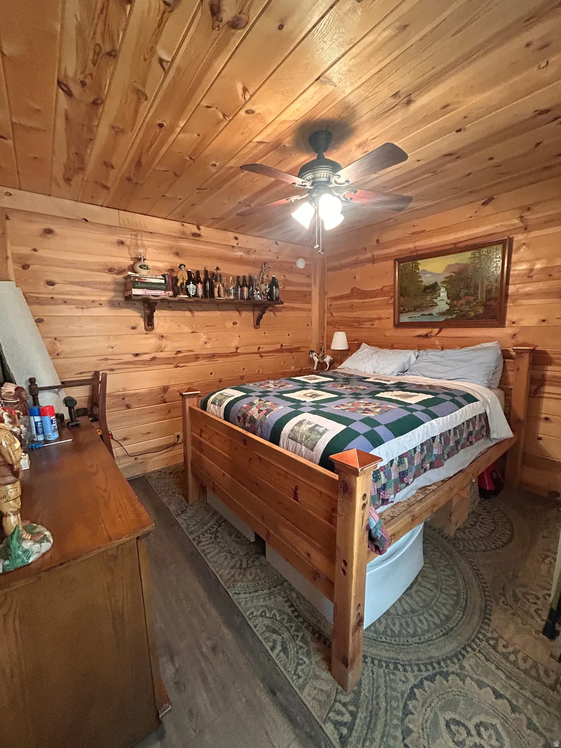 Wood-paneled room featuring a coordinating wood-finish bed frame