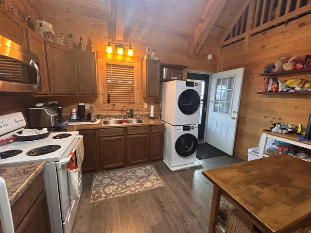 Kitchen area featuring wood-finish flooring and wood paneling