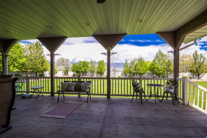 Expansive covered patio featuring a stamped concrete surface and a slatted ceiling