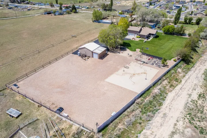 Expansive gravel-surfaced area featuring a sandy volleyball court