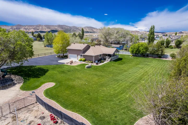 Expansive green lawn with mountain backdrop