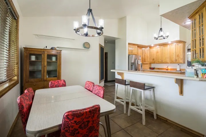 Open-concept dining area with tile flooring and a view of the kitchen