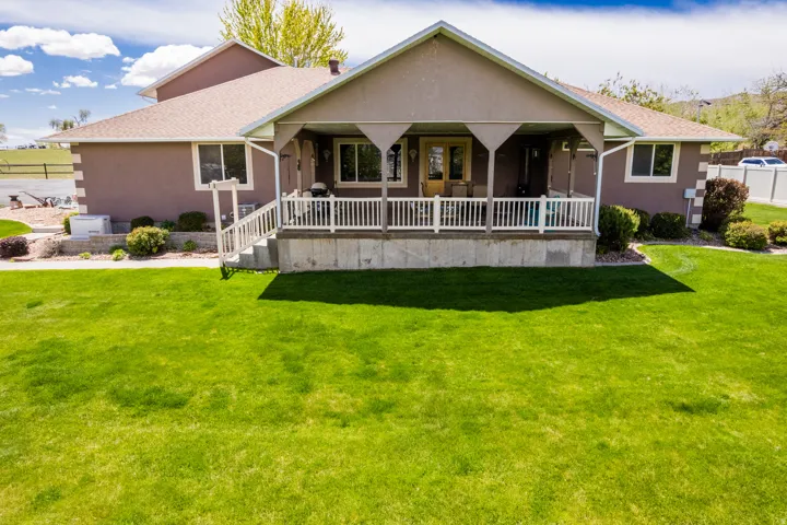 Expansive front lawn with a stucco exterior
