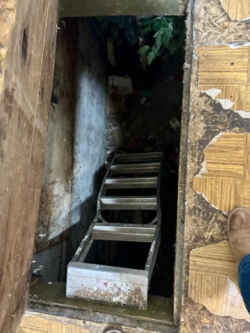 Cellar door under the kitchen floor.