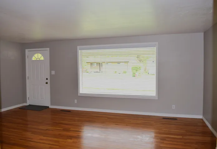 Living space featuring wood-finish flooring, and white baseboards