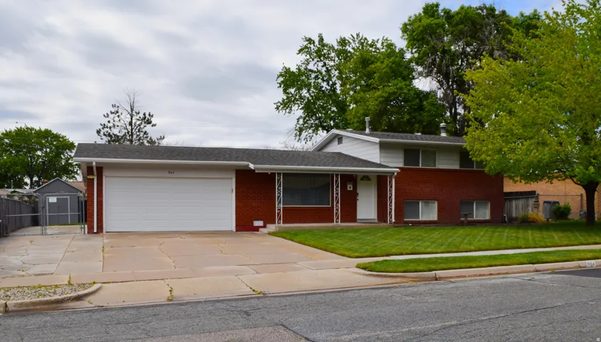 Red brick and white siding exterior with a two-car garage
