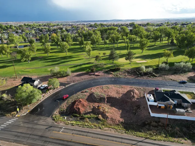 Expansive green space featuring mature trees and a golf course aerial perspective showcasing a residential lot looking SOUTH
