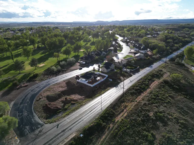 Elevated property with surrounding roads, a residential area, and a golf course looking WEST