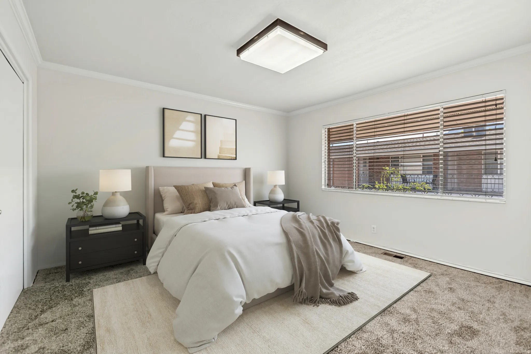 Bright room featuring a large window with horizontal blinds, neutral wall paint, crown molding, and plush carpet flooring