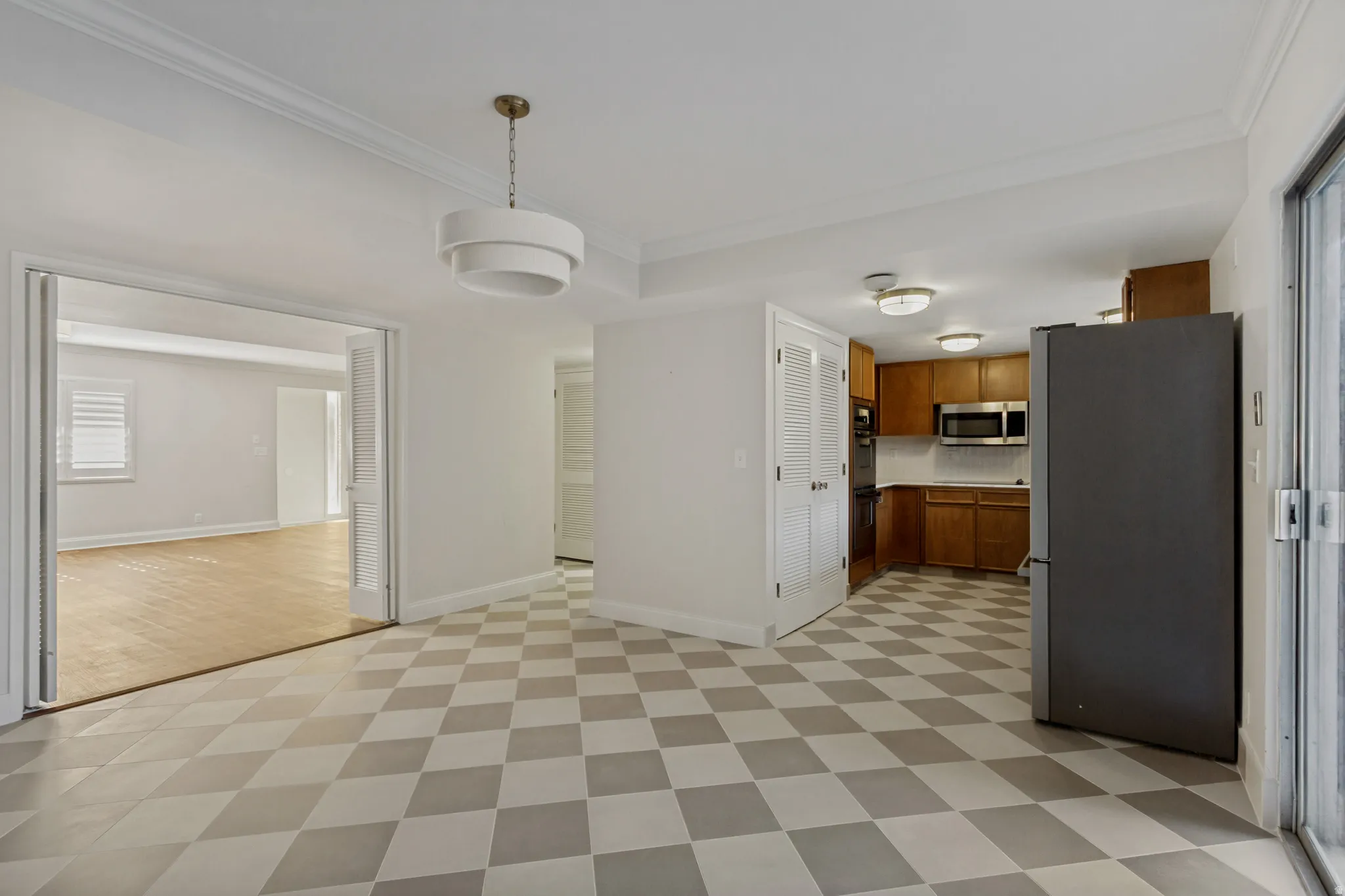 Checkerboard flooring, white walls, and a contemporary chandelier