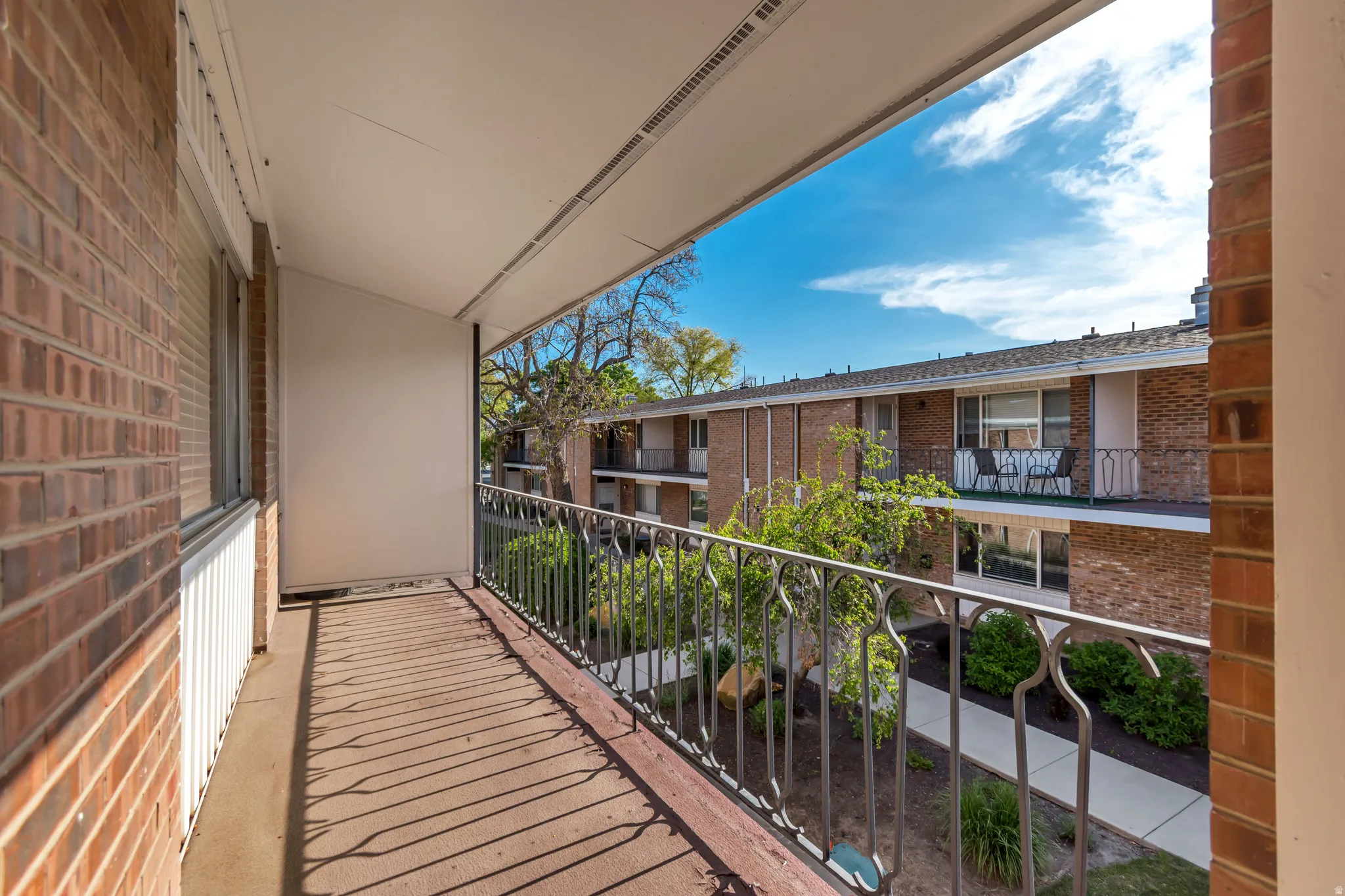 Private balcony featuring a concrete floor and black metal railing