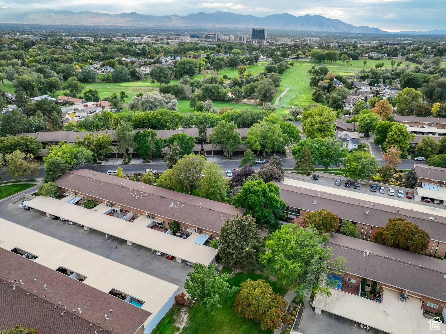 Aerial perspective showcasing residential buildings with brown roofs and multiple covered parking structures