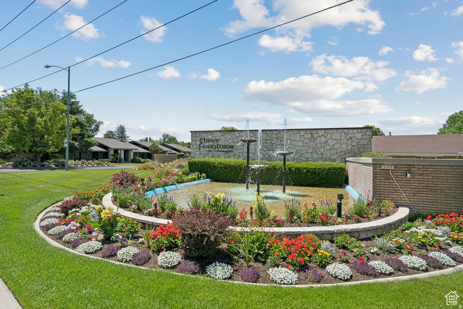 Three-tiered fountain feature within a circular flower bed