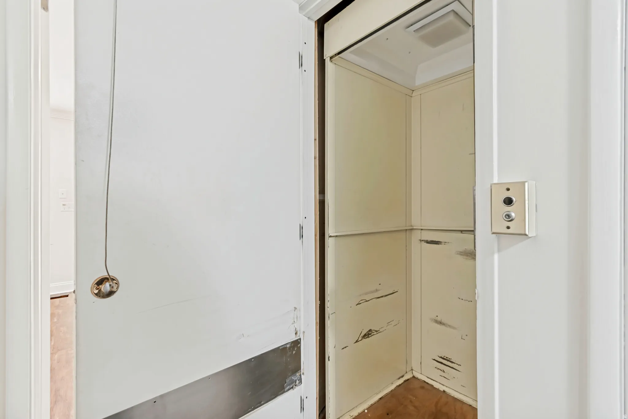 Built-in residential elevator featuring interior lighting and external call buttons